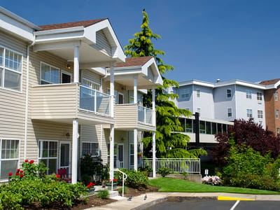 Exterior view of the facility with gardens and balconies.