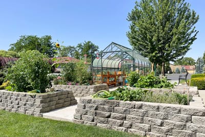 Garden area with raised beds and greenhouse