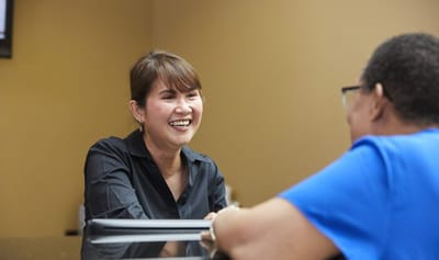 Staff member smiling while interacting with a resident.