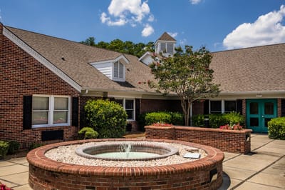 Outdoor courtyard with a fountain and landscaping