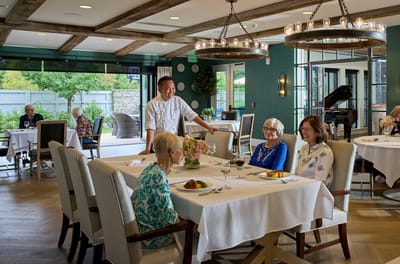 Residents enjoying a meal in a dining area.