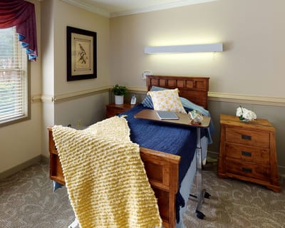 Cozy private resident room with comfortable bedding.