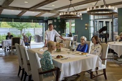 Residents enjoying a meal in a dining area.