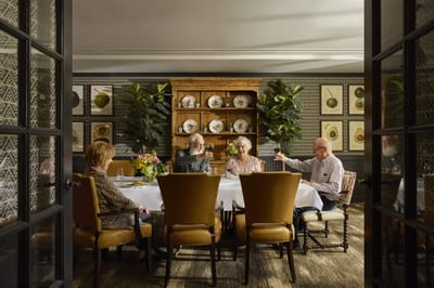 Residents enjoying a meal in a dining room.