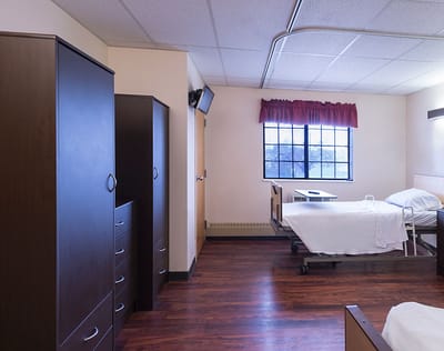 Bright, clean resident bedroom with furniture
