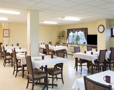 Dining room with tables and chairs, plants in the window
