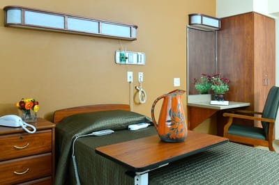 Cozy resident room with a floral arrangement and a pitcher.
