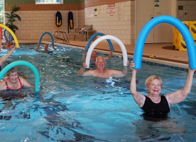 Residents participating in water aerobics in a pool