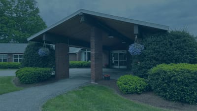 Entrance of a senior living facility with landscaping