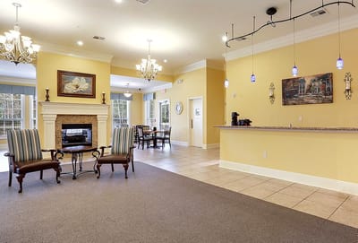 Bright common area with seating and fireplace