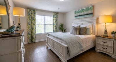 Cozy decorated resident room with bed and window