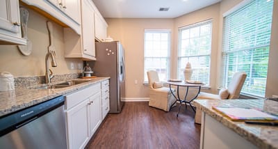 Bright kitchen area with dining space and windows