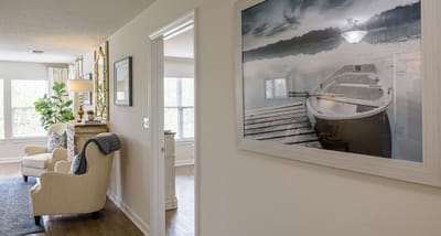 A cozy living area with a boat painting on the wall