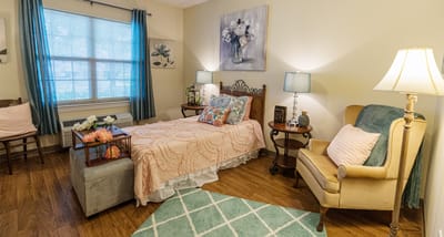 Brightly decorated resident room with cozy furnishings