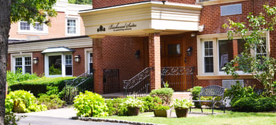 Exterior view of Birchwood Suites with landscaped entrance