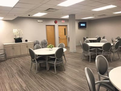 Bright common area with dining tables and chairs