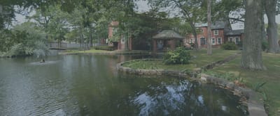 Scenic outdoor view of a pond and buildings