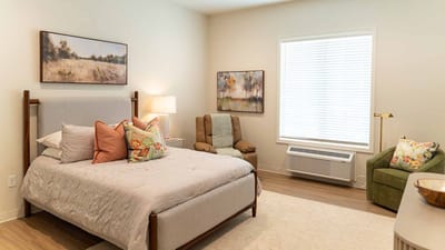 Cozy resident room with bed and artwork