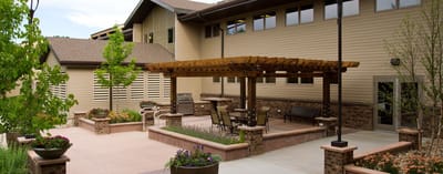 Outdoor patio area with seating and greenery