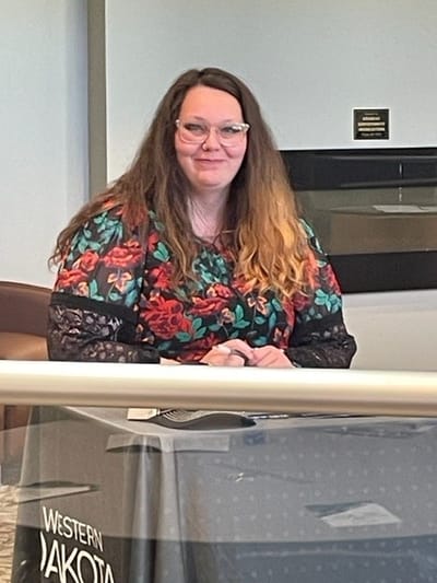 Resident staff member at a table in the facility