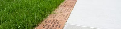 Close-up of engraved bricks in grass