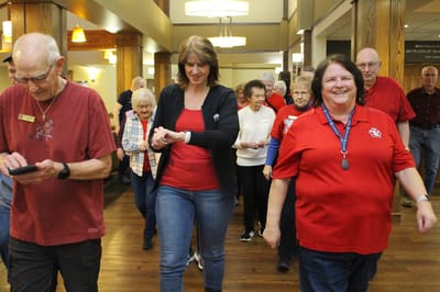 Residents and staff walking together in a common area