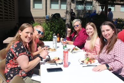Residents enjoying a meal outdoors at a social event