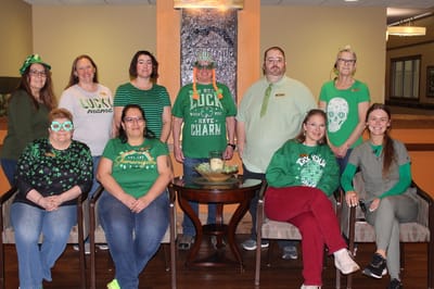 Staff members in green attire celebrating St. Patrick's Day