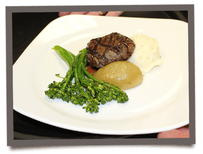 A gourmet meal served with vegetables and mashed potatoes