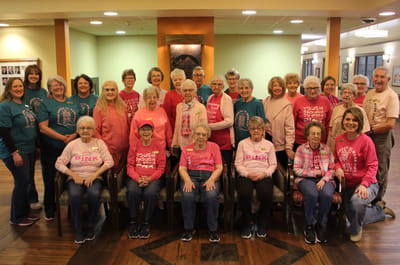 Residents posing in a common area during a themed event