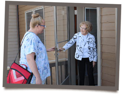 Staff greeting a resident at the entrance