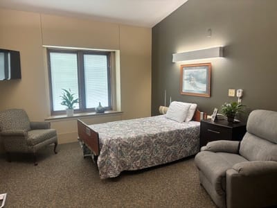 Cozy resident room with bed and seating area