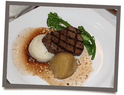 A plated meal of steak, mashed potatoes, and vegetables
