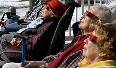 Residents enjoying the sun outdoors in colorful sunglasses