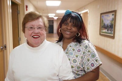 Residents smiling in a hallway