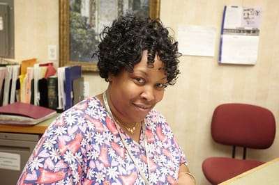Staff member smiling at front desk