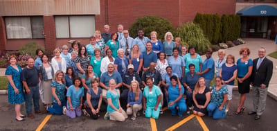 Group photo of staff outside the facility