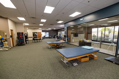 Interior view of a therapy room with equipment and staff
