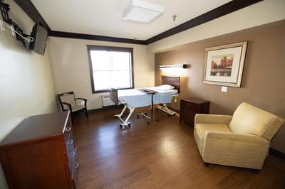 Private resident room with bed and seating area