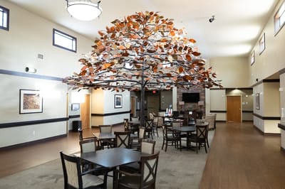 Interior view of a common area with artistic tree decor