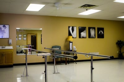 Interior room with rehabilitation bars and artistic photographs