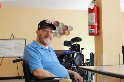 Resident sitting in a common area of the facility