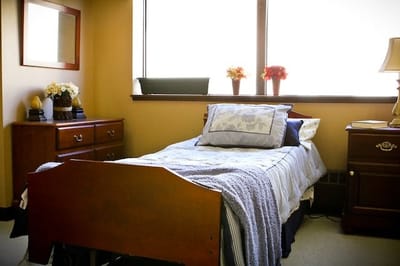 Cozy resident room with bed and window