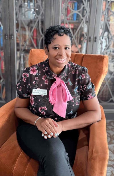 Staff member posing in a common area.