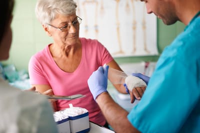 Senior receiving care from medical staff.
