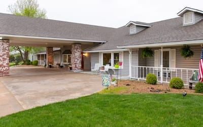 Exterior view of a senior living facility with garden.