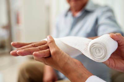 Medical care with a bandaged hand.