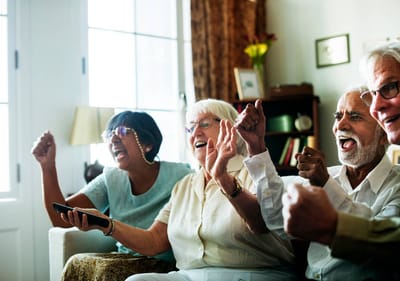 Residents celebrating and enjoying a lively moment indoors.