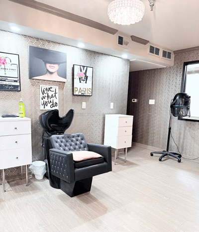 Beauty salon area with styling chair and decor