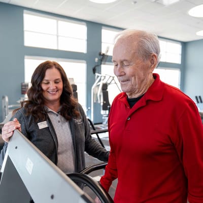 Therapist assisting a resident in fitness area